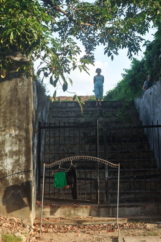 On the Citadel Wall, Hue, Vietnam. As I walked along the street inside the citadel, I glanced over and was startled to see this old woman just standing at the top of the stairs up to the wall, staring.  I have no idea how she got up there.  All the gates to the wall seemed closed and locked.